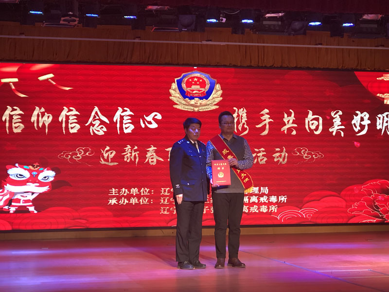 省司法廳副廳長椰永濤（左）為宋曉頒發(fā)聘書，佩戴戒毒公益大使綬帶