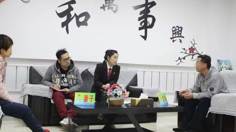 記者（左二）與法官張楊在家事調(diào)解室中開導(dǎo)夫妻二人