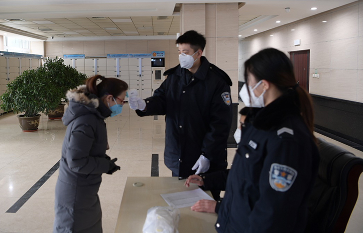 鞍山中院法警正在給到院的當(dāng)事人測體溫